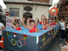 a group of people riding on the back of a float