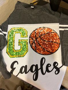 This design is called GO COMETS This design is A Direct To Film in design and is a faux sequin print and is customizable for colors and school name and sport.  Please specify colors in personalization section.  If you prefer no glitter and no stones it will be done in Direct To Film and please specify under personalization. If you like a Design but not the right colors or mascot or school name, no problem, ALL of my designs can be altered.  I specialize is complete customization.   This design is offered on a Crewneck Fleece, Softstyle Tee, Zen Vintage Hoodie (popular items) NuBlend Hoodie, Softstyle Long Sleeve Tee or any of my blank apparel in my shop.  When picking from my blank apparel please order that listing and specify which design you would like added to the blank apparel.  All my Eagles Basketball, Film Design, Blank Apparel, Spirit Shirts, Vintage Hoodie, Custom Glitter, School Team, Spirit Wear, Team Name