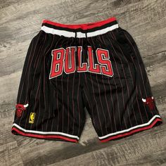 Chicago Bulls Black Pinstripe Spellout Basketball Shorts Fits L-XL Casual Athletic Shorts With Built-in Shorts For Basketball, Cotton Three Stripes Streetwear Shorts, Basketball Team Spirit Shorts For Sports Season, Basketball Team Spirit Shorts, Casual Team-colored Basketball Shorts, Casual Basketball Shorts In Team Colors, Casual Cheerleading Shorts, Casual Shorts For Cheerleading, Casual Shorts For Cheerleading During Sports Season