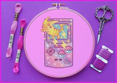 a cross stitch pattern with scissors, thread and spools on a purple background