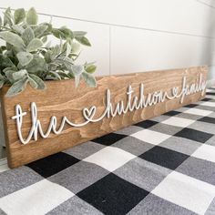 a wooden sign that says the shutdown family on it next to a potted plant