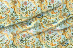 a blue and yellow fabric with an ornate design