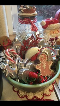 a bowl filled with lots of different types of cookie cutters and other holiday decorations