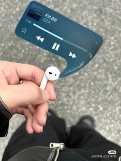 a person holding an mp3 player in their hand