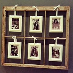 an old wooden frame hanging on the wall with pictures hung in it and tied to strings