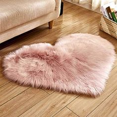 a pink heart shaped rug on the floor