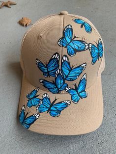 a tan hat with blue butterflies on it