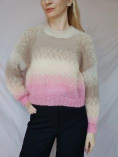 a woman wearing a pink and white sweater