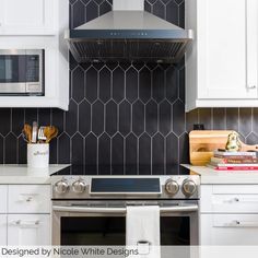 a stove top oven sitting inside of a kitchen next to white cabinets and counter tops