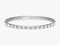 a white bracelet with clear stones on the front and back ends, set in 18k white gold