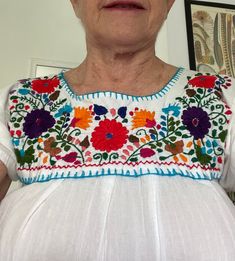 This beautifully hand embroidered Mexican short sleeved blouse has hardly been worn. It's in pristine condition. The body of the blouse is made of gauze cotton and the embroidered bodice is a regular heavier cotton. Full of colors and types of flowers it exudes happiness! Here are the measurements: 17" shoulder to shoulder 16" Pit to pit with a bit of stretch/gathers 25" long You can also follow me on Instagram! @divine_reinvention Short Sleeved Blouse, Mexican Blouse, Embroidered Bodice, Types Of Flowers, Short Sleeve Blouse, Festival Season, Womens Clothing Tops, Heavy Cotton, Hand Embroidered