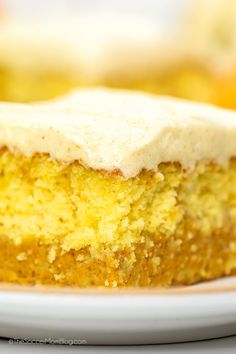 a piece of cake sitting on top of a white plate with frosted icing