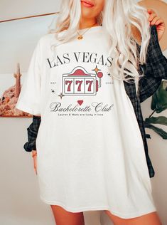 🎉 Hit the jackpot with our 'The Bach Club Shirt', the ultimate pick for your Las Vegas Bachelorette party! This shirt isn't just a piece of clothing; it's your ticket to an unforgettable celebration in the city of lights and luck. 🌟 Why It's a Must-Have: Vegas-Ready: Embrace the glitz and glamour of Las Vegas with our Retro Casino Tee, perfect for making a statement on the Strip. Bride Squad Style: Customize for each member of your bridal party, making these Custom Bride Shirts a special keepsake for everyone. Picture-Perfect: These shirts are not only fun and stylish but also make for great photo ops, capturing the spirit of your bachelorette bash. Quality You'll Love: Made with soft, durable fabric, these shirts are designed to keep up with a night of festivities and fun. 🎁 Ideal For: Casino Bachelorette Party, Casino Bachelorette, Retro Casino, Vegas Bachelorette Shirts, Theme Bachelorette Party, Las Vegas Bachelorette Party, Vday Cards, Las Vegas Bachelorette, Vegas Bachelorette Party