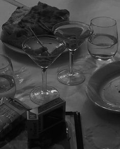 a table topped with glasses and plates filled with food