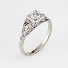 an antique style diamond engagement ring in white gold