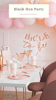 a party table with pink balloons and champagne glasses on it, including one for the bride to be