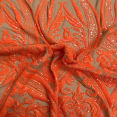 an orange fabric with sequins on it