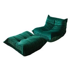 a green chair and ottoman with pillows on it's sides, in front of a white background