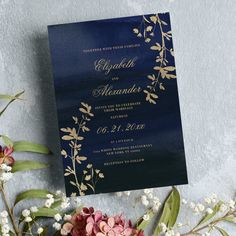 a wedding card with flowers and greenery