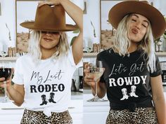 two women wearing nashville girls trip t - shirts and holding wine glasses in their hands