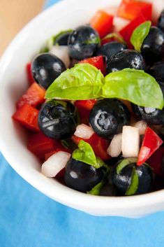 two small bowls filled with blueberries and other fruit