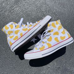 GO BANANAS with our Banana Bunches High Top Converse! These white high tops have a repeating pattern on the outside and inside panels of both shoes. We buy each pair of shoes BRAND NEW. Each pair is made to order, please make sure you put in the correct shoe size before you check out. The paint is permanent and will never come off, fade away, or peel off. Made in the USA. This price includes everything: shoes, artwork, and shipping. Thanks for stopping by our Etsy shop! Please message me with an White Sneakers With Gum Sole For Summer, White Slip-on High-top Casual Sneakers, White High-top Canvas Shoes With Speckled Midsole, Casual White High-top Custom Sneakers, White Custom Sneakers For Summer Streetwear, Trendy White High-top Sneakers With Gum Sole, White High-top Casual Custom Sneakers, Trendy White High-top Sneakers With Speckled Midsole, Trendy White High-top Custom Sneakers