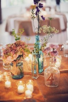 an instagram photo with flowers in vases and candles on the table for decoration