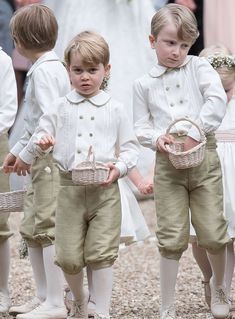 the young children are dressed in white outfits