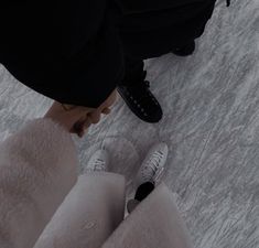 a person standing on top of a snow covered ground with their feet in the air