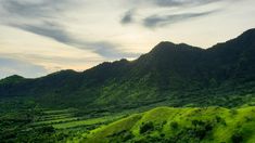 the green mountains are covered in lush vegetation