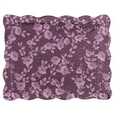 a purple flowered pillow on a white background