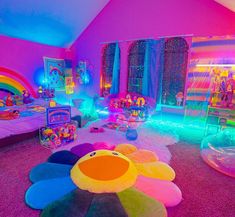 a room with lots of toys and decorations on the floor in front of a rainbow colored wall