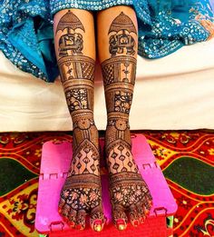 the legs and feet of a woman with henna tattoos