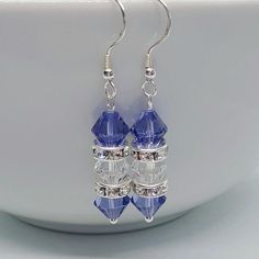 Sterling Silver & Crystal (from Swarovski®) Earrings, Blue Crystal Earrings, Blue Crystal Jewellery, 925 Silver Jewellery, Gift For Her These stunning earrings are made using Swarovski® Crystal 5328 beads in Tanzanite & Crystal and Swarovski® Crystal Silver Plated Rondelle spacers on Sterling Silver earring hooks. The drop is approx 3cm. These would make such a beautiful gift or perfect for a bride to wear on her special day! These will come wrapped in tissue paper and placed in a purple velvet pouch. PLEASE NOTE ~ post can take up to 2 weeks to arrive within the UK at the moment, and up to 32 working days to arrive in the USA. Blue Sterling Silver Crystal Earrings For Pierced Ears, Blue Sterling Silver Crystal Earrings, Blue Earrings With Ear Wire For Anniversary, Blue Ear Wire Earrings For Anniversary, Blue Earrings For Anniversary, Blue Anniversary Earrings With Ear Wire, Nickel-free Blue Earrings For Anniversary, Blue Crystal Earrings With Sterling Silver Ear Wire, Blue Nickel-free Earrings For Anniversary