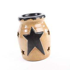 a ceramic jar with a black star on it