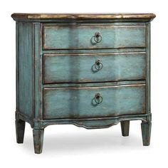 an old blue dresser with two drawers on one side and brass knobs on the other