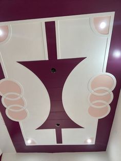 the ceiling is decorated with pink and white circles