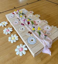 the table is set up with paper flowers and plates