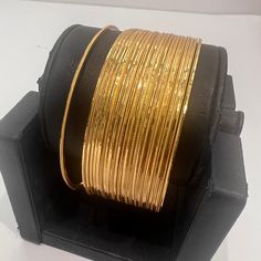 "* Handcrafted Gold Plated Bangle Set * High Quality 22 K Gold Plated 24 pc. Bangle set * Size: 2.2 has 2.2\" inner circle diameter ; 2.4 ( 2.31\" inner circle diameter) ; 2.6 ( 2.46\" inner circle diameter); 2.8 (2.64\" inner circle diameter) * Sold as a set of 24 bangles A gorgeous gold-plated bangle/ bracelet best exemplifies the careful craftsmanship done on it -- a specialty at Nemali Jewelry. It has a special tone of elegance attached to it. The intricate handmade design of the bangle / br Indian Wedding Bangles, Gold Bangles Set, Dubai Gold Bangles, Simple Gold Bangle, Plain Gold Bangles, 22k Gold Bangles, Wedding Bangles, Indian Bangles, Gold Bangles For Women