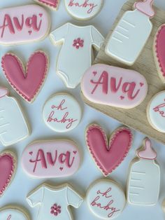 decorated cookies with pink and white icing on a table