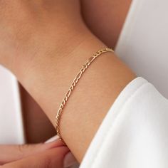 Our new simple and dainty Figaro chain bracelets, as always made in 14k solid gold. You can wear this bracelet with a free mind without worrying about water, perfume, or conditioner contact since real gold never tarnishes.★ Features of the Bracelet (this listing is for a single bracelet only)• Gold Kt: 14K Solid Gold (all pieces are stamped for authenticity)• Available Gold Color: Yellow Gold• Chain Width: 2.5 mm 14k Yellow Gold Bracelet With Simple Design, Simple 14k Yellow Gold Bracelet, Yellow Gold 14k Bracelet, 14k Gold Adjustable Bracelet, Minimalist 14k Gold Charm Bracelet With Delicate Chain, Simple 14k Gold Bracelet Gift, Minimalist Figaro Chain Bracelet, Dainty Tarnish Resistant Rose Gold Bracelet, Everyday 14k Rose Gold Chain Bracelet