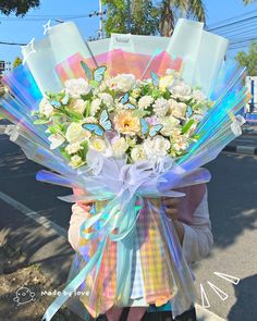 a woman holding a bouquet of flowers on the street