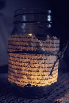 a jar filled with some kind of paper on top of a table