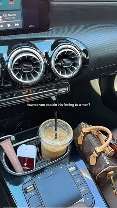 the interior of a car with an electronic device and other items on display in it