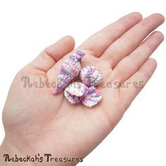 small crocheted flowers in the palm of someone's hand