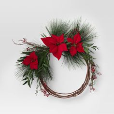 a christmas wreath with red poinsettias and greenery