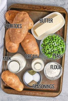 potatoes, peas, butter, cream and seasonings on a baking sheet with text overlay