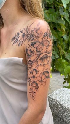 a woman with a flower tattoo on her arm