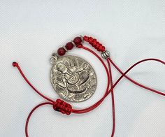 Three different variations of Ganesh:  1) brown and brass micro pave Ganesh elephant crystal tassel green silk cord necklace with malachite accent bead. Adjustable with woven Tibetan knot slide made by me. Wear it long or short.  2) red chord with round silver charm Ganesh with red carnelian beads on red silk cord necklace. Adjustable with woven Tibetan knot slide made by me. Wear it long or short.  3) blue chord silver Ganesh elephant Tibetan charm and tiger eye accent bead. Adjustable with wov Bohemian Silver Necklace With Sliding Knot, Spiritual Necklace With Adjustable Cord, Adjustable Gemstone Beads Jewelry For Festivals, Handmade Silk Cord Necklaces As Gift, Handmade Silk Cord Necklace For Gifts, Hand Knotted Spiritual Jewelry For Festivals, Spiritual Hand-knotted Jewelry For Festivals, Spiritual Jewelry With Sliding Knot For Festivals, Traditional Jewelry With Sliding Knot For Gifts