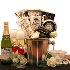 a champagne bucket filled with lots of different types of wine and other items on a table